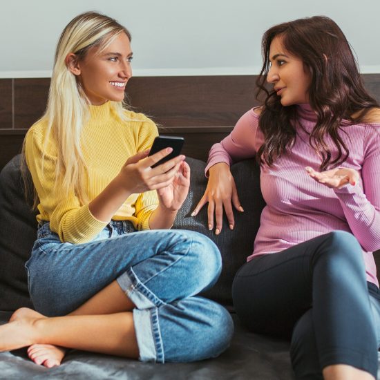 Female Friends on a Couch Talking